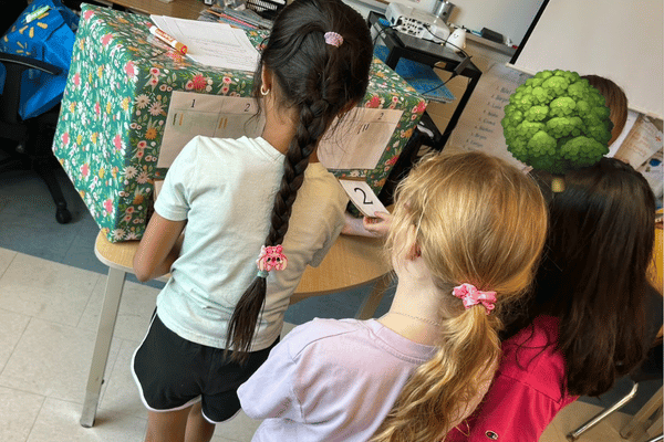 Children playing a guessing game about local food